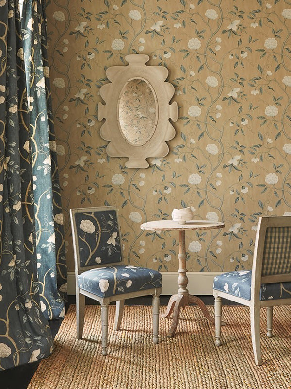 Colefax and Fowler wallpaper featuring a gold floral print in a living room setting