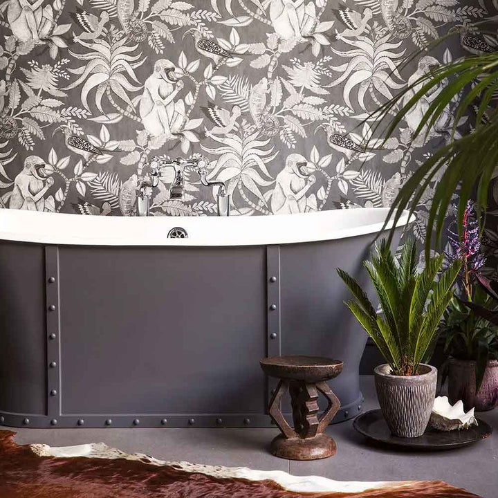 Cole & Son Savuti Wallpaper in charcoal featured on a bathroom wall.