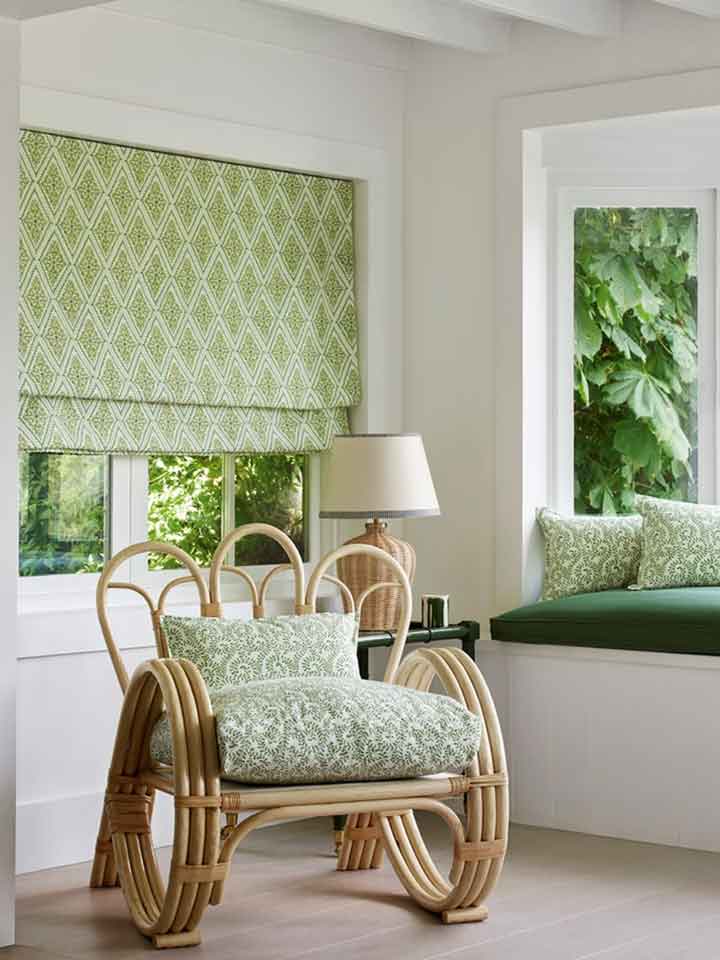 Fabrics | Jane Churchill Fabrics | Image features a sitting room with feature wooden chair adorned with jane churchill fabrics in a botanical green print & matching roman blind