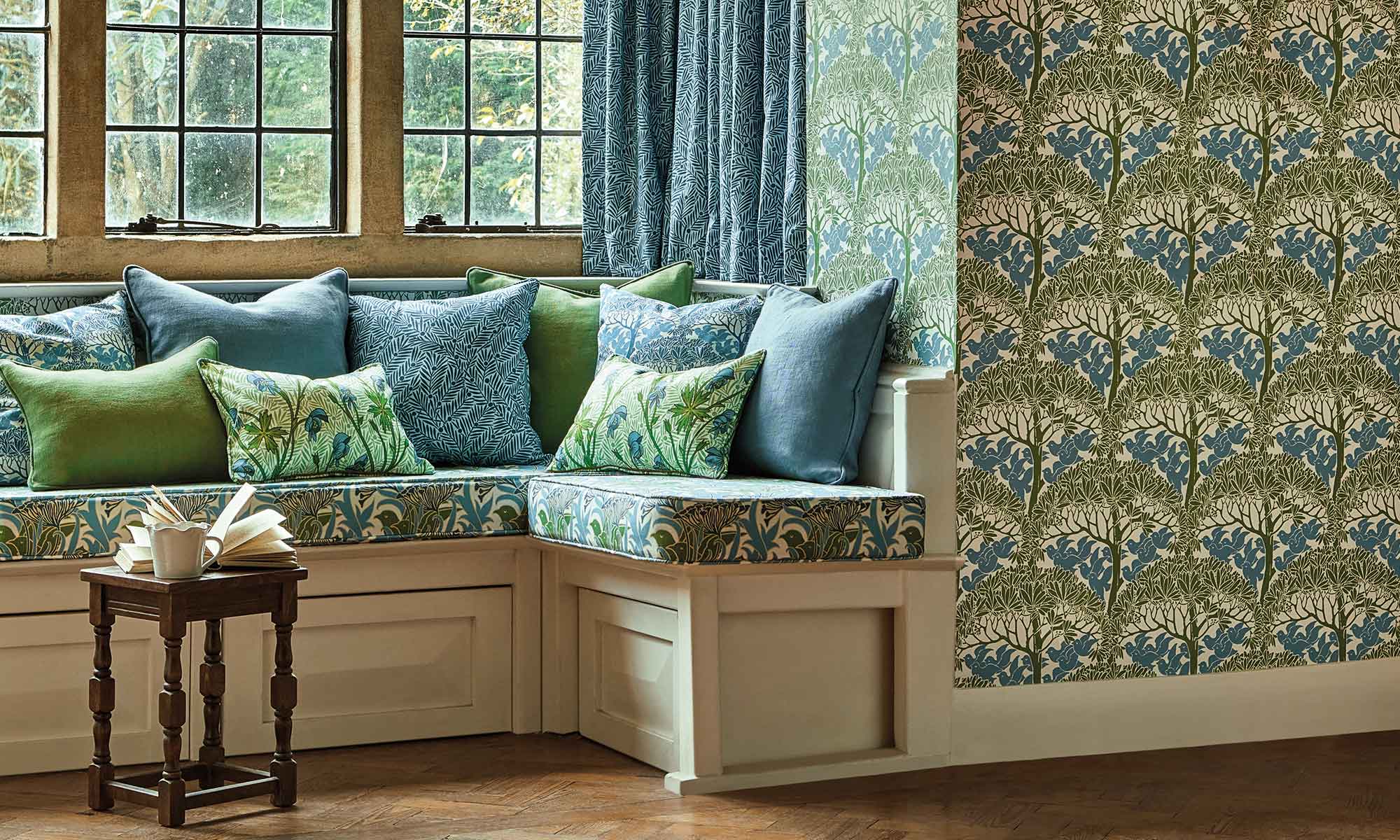 Morris & Co Bedford Park Wallpaper & Fabric Collection | Alcove sitting area with wallpaper featuring green & blue foral print
